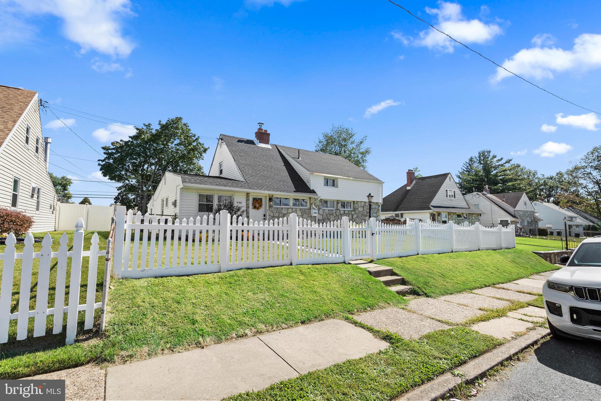 a view of a house with a yard and porch