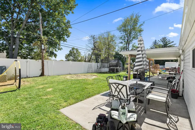 a view of a backyard with a patio and outdoor seating