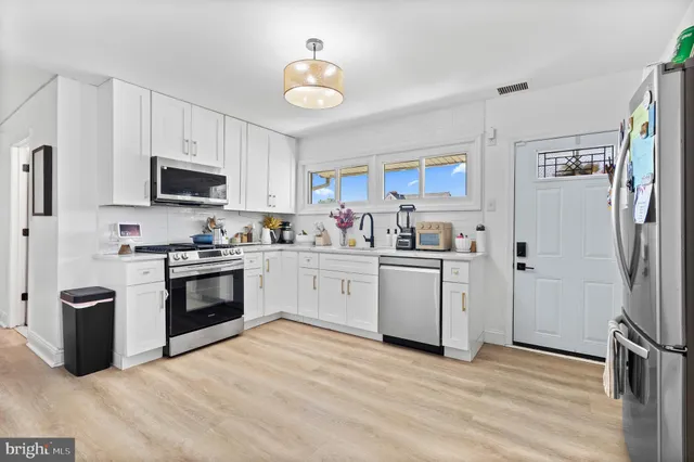 a kitchen with a refrigerator stove and a sink