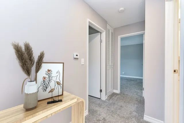 an empty room with closet and a ceiling fan