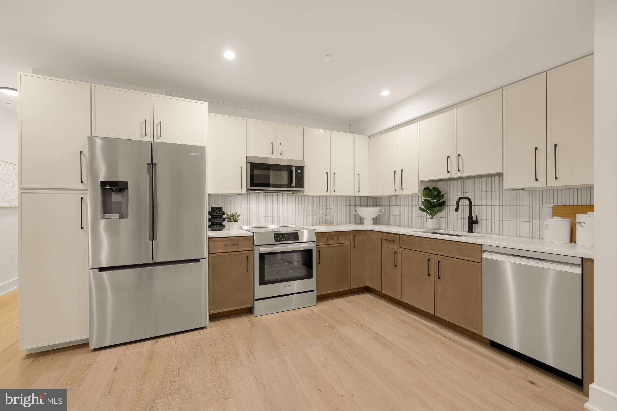 1463 Harvard Street Northwest, Unit 2 Washington, DC 20009 - Photo 8 of 25 a kitchen with cabinets stainless steel appliances and a counter space
