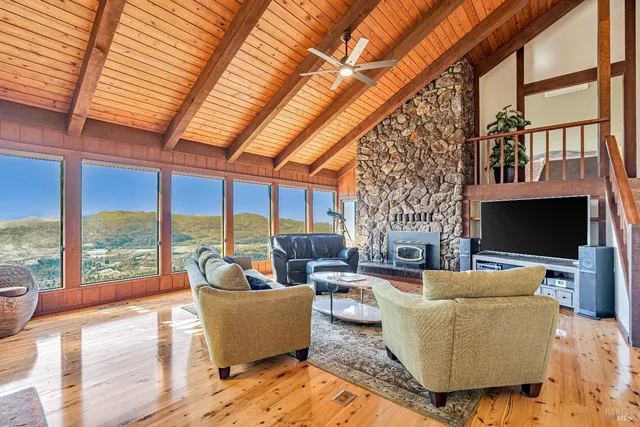 a living room with fireplace furniture and a flat screen tv