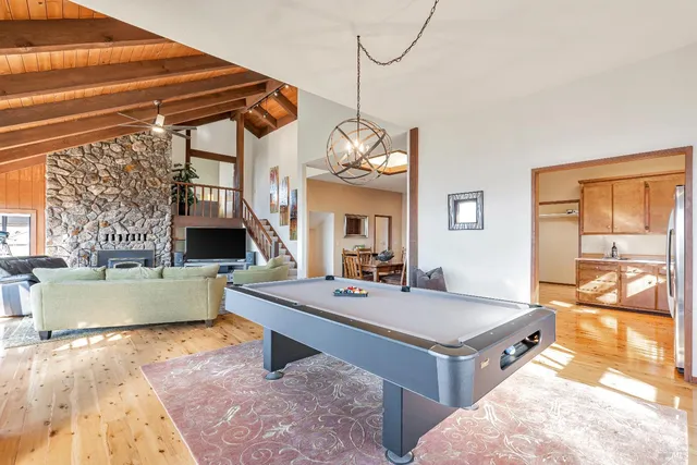 a room with a table chairs and a kitchen view