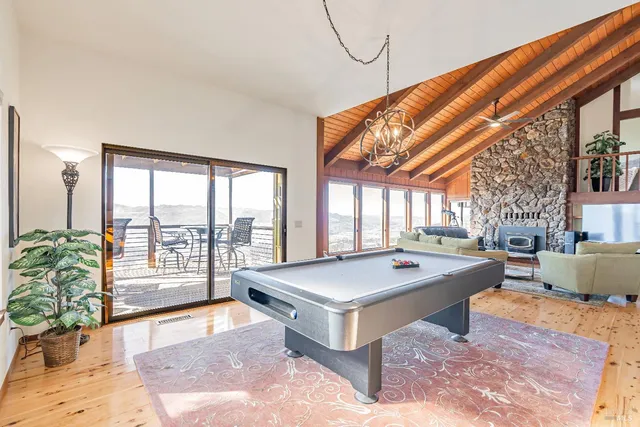 a very nice looking living room with a large window and a table