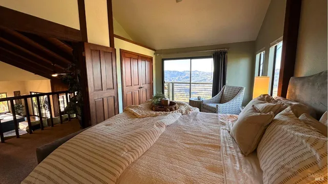 a bedroom with a large bed and a large window
