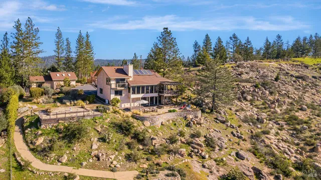 a view of a house with a yard and sitting area