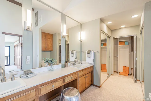 a spacious bathroom with a double vanity sink mirror and double