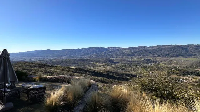 a front view of a house with a garden and yard