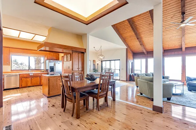 a dining area with furniture and a large window