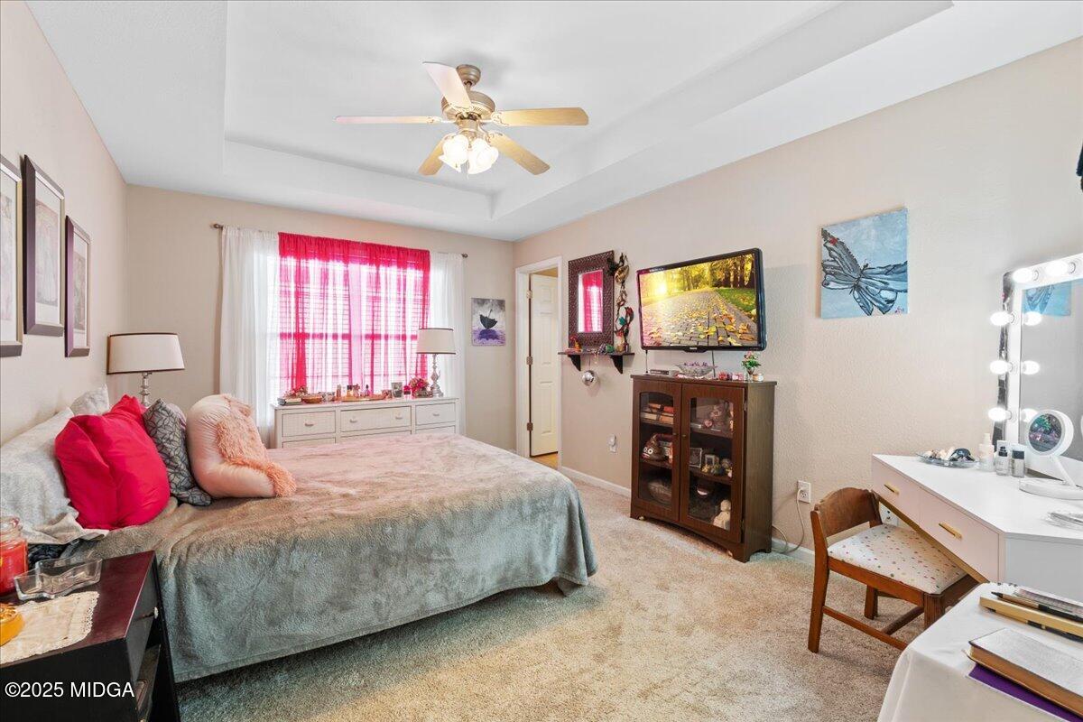 125 Amber Drive Byron, GA 31008 - Photo 17 of 27 a bedroom with a bed and a flat screen tv