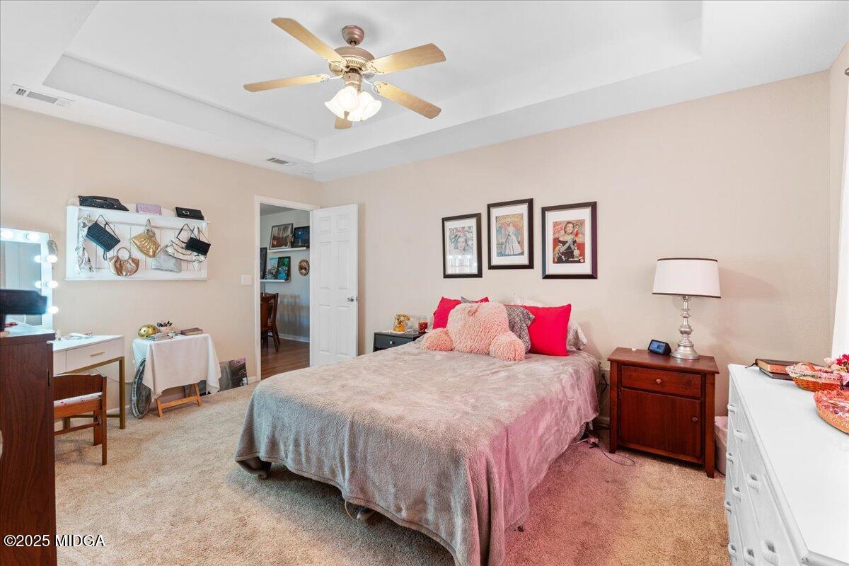 125 Amber Drive Byron, GA 31008 - Photo 18 of 27 a bedroom with a bed and a chandelier