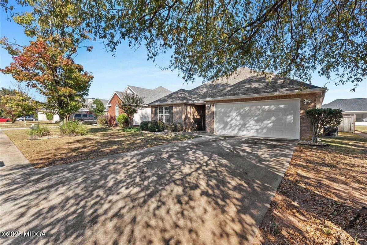 125 Amber Drive Byron, GA 31008 - Photo 2 of 27 a front view of a house with a garden