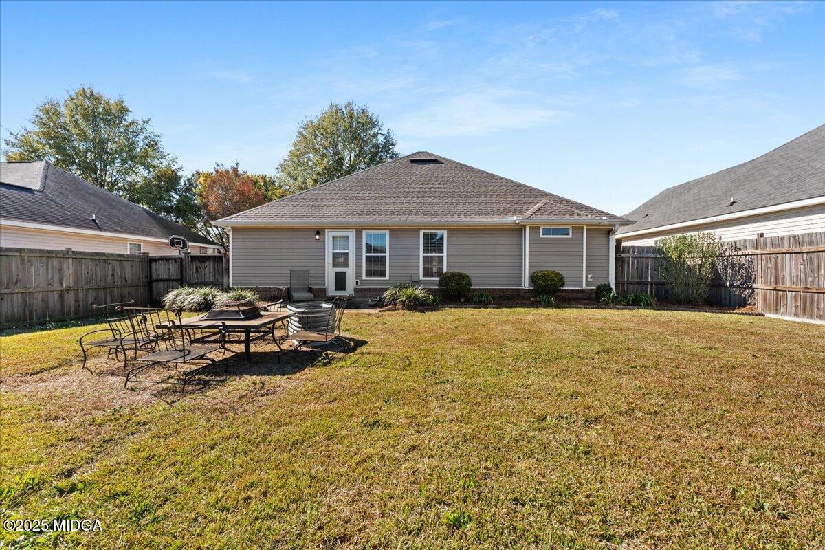 125 Amber Drive Byron, GA 31008 - Photo 25 of 27 a view of a white house with a swimming pool and a yard