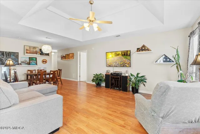 a living room with furniture and a chandelier