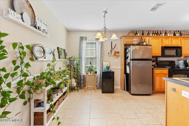 a kitchen with refrigerator and window