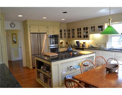 6 Palmer Terrace Riverside, CT 06878 - Photo 4 of 16 a kitchen with stainless steel appliances granite countertop a stove a refrigerator a sink a dining table and chairs with wooden floor