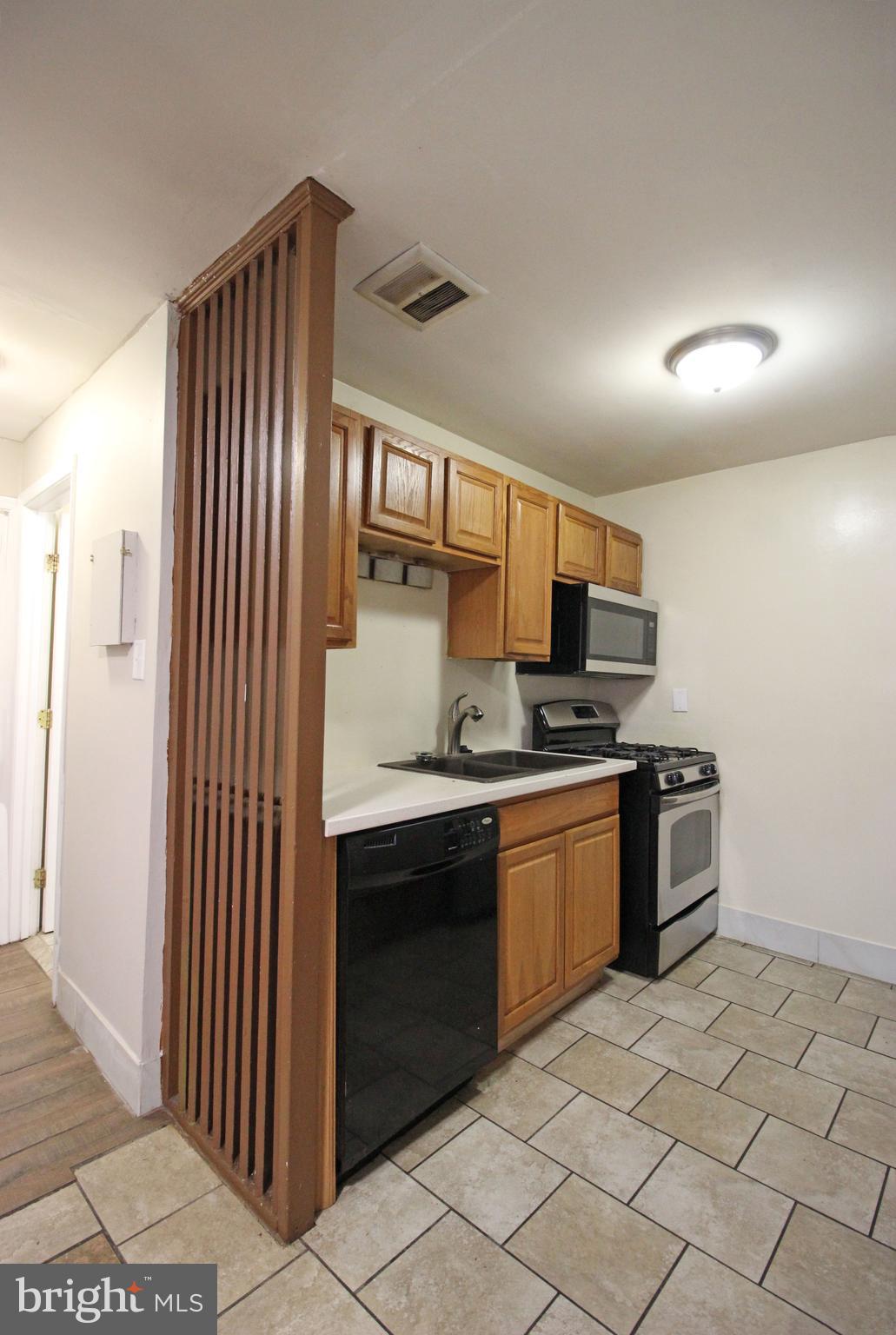 17 Water Street, Unit 30 Gaithersburg, MD 20877 - Photo 13 of 18 a kitchen with stainless steel appliances granite countertop a stove and a sink