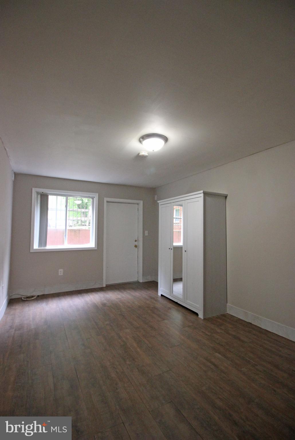 17 Water Street, Unit 30 Gaithersburg, MD 20877 - Photo 17 of 18 an empty room with wooden floor and windows