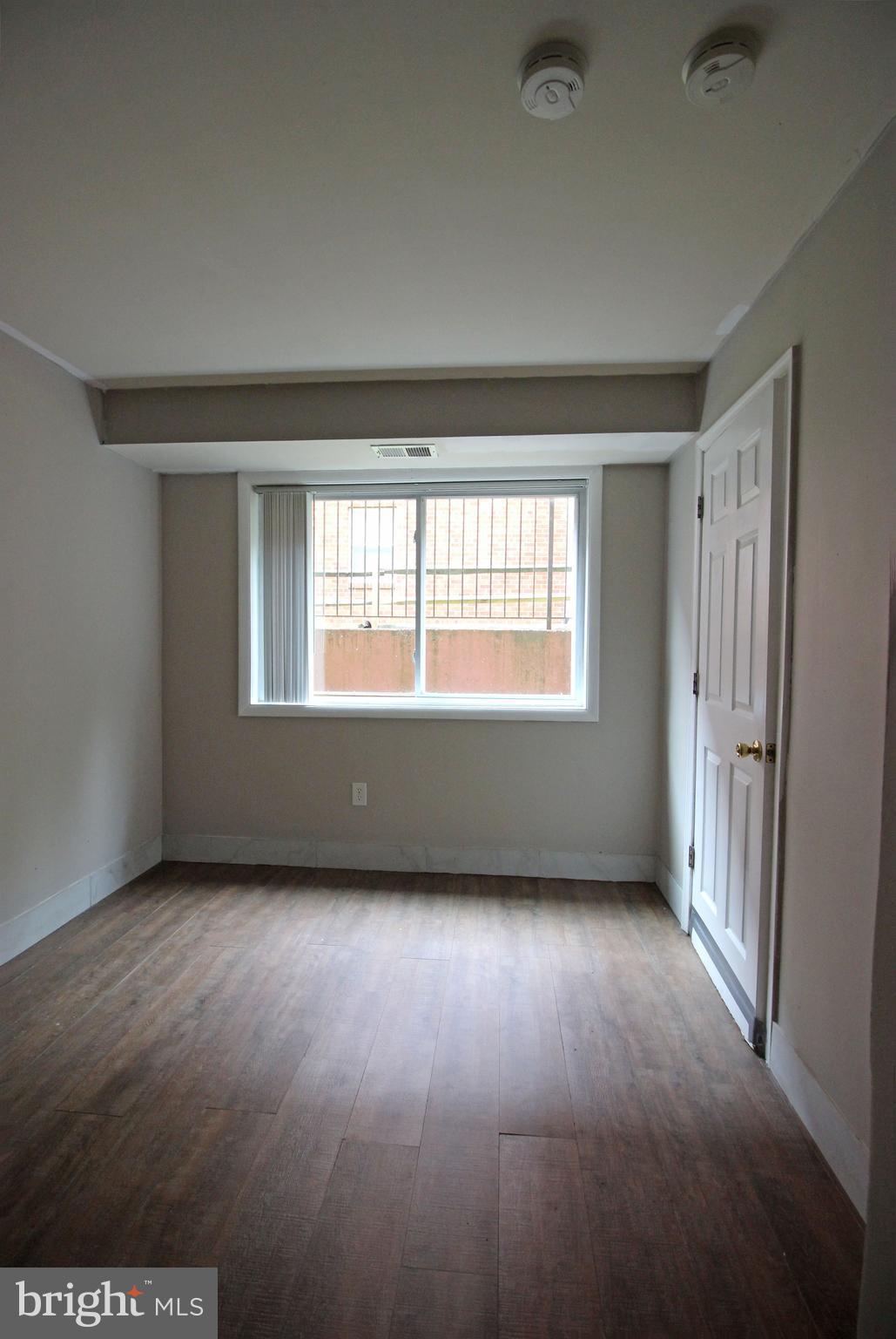 17 Water Street, Unit 30 Gaithersburg, MD 20877 - Photo 9 of 18 a view of an empty room with wooden floor and a window
