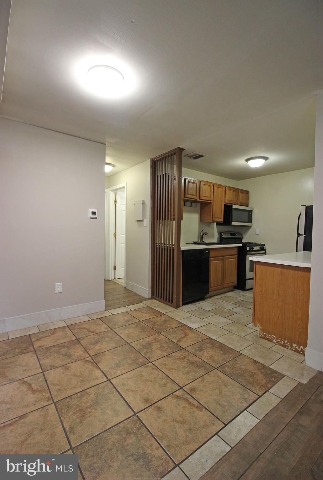 17 Water Street, Unit 30 Gaithersburg, MD 20877 - Photo 10 of 18 an empty room with kitchen view and a window