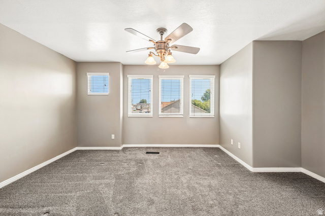 3215 West 450 North West Point, UT 84015 - Photo 13 of 40 Interior room featuring neutral wall paint, gray carpeting, a ceiling fan with integrated lighting, and multiple windows with horizontal blinds