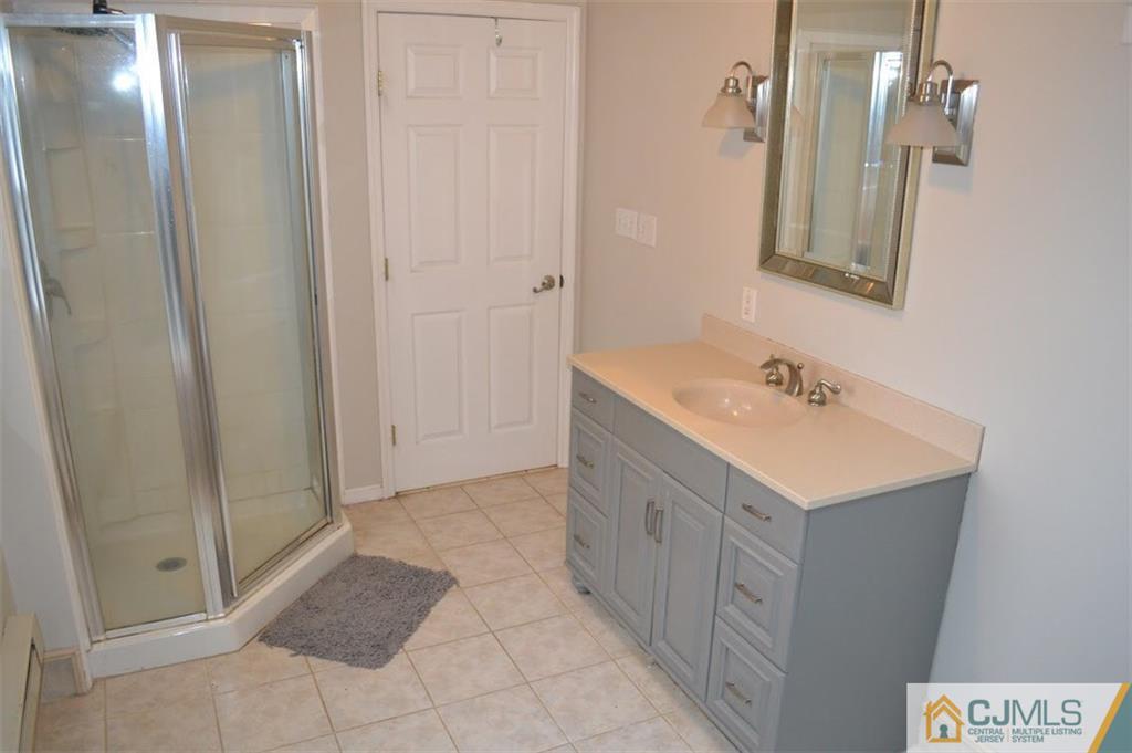 641 Scotch Road Pennington, NJ 08534 - Photo 14 of 24 a bathroom with a sink a mirror and a shower