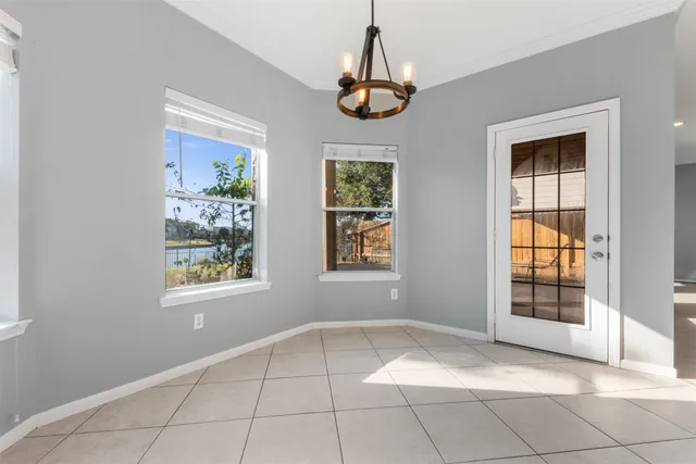 a large kitchen with kitchen island a large counter top stainless steel appliances and cabinets