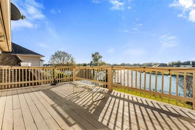 a view of balcony with wooden floor and fence