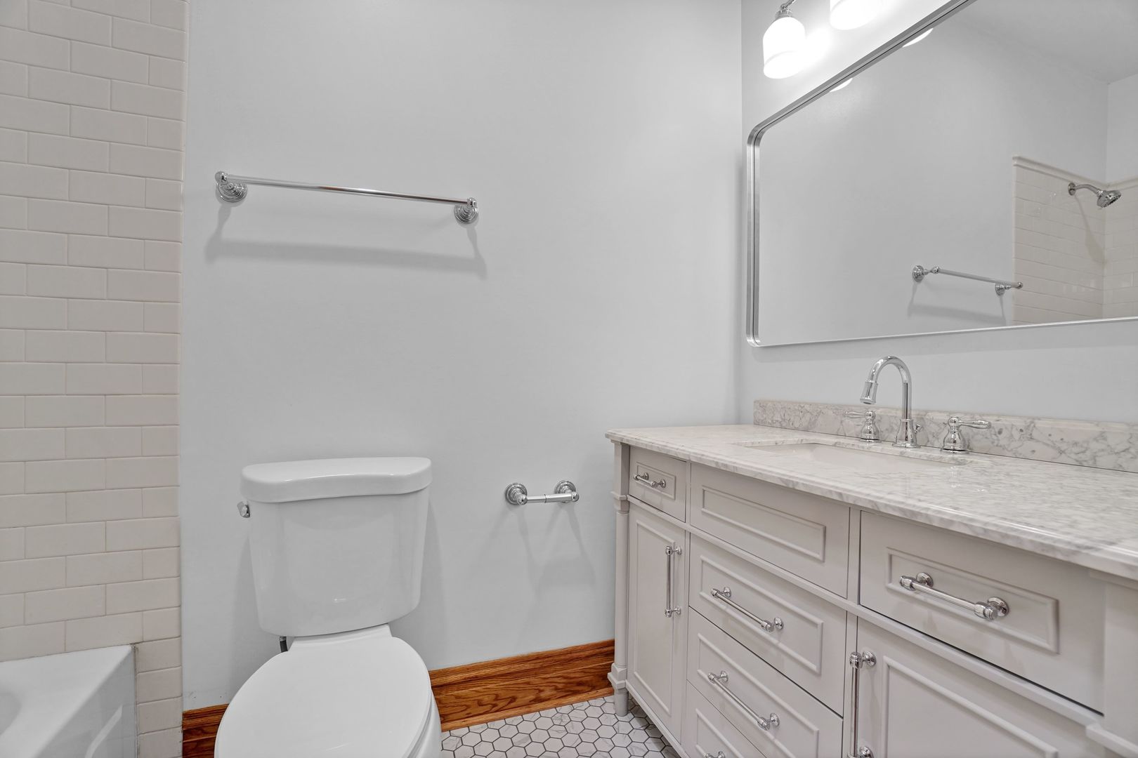 849 West Grace Street, Unit 2 Chicago, IL 60613 - Photo 14 of 19 a bathroom with a granite countertop toilet sink and mirror