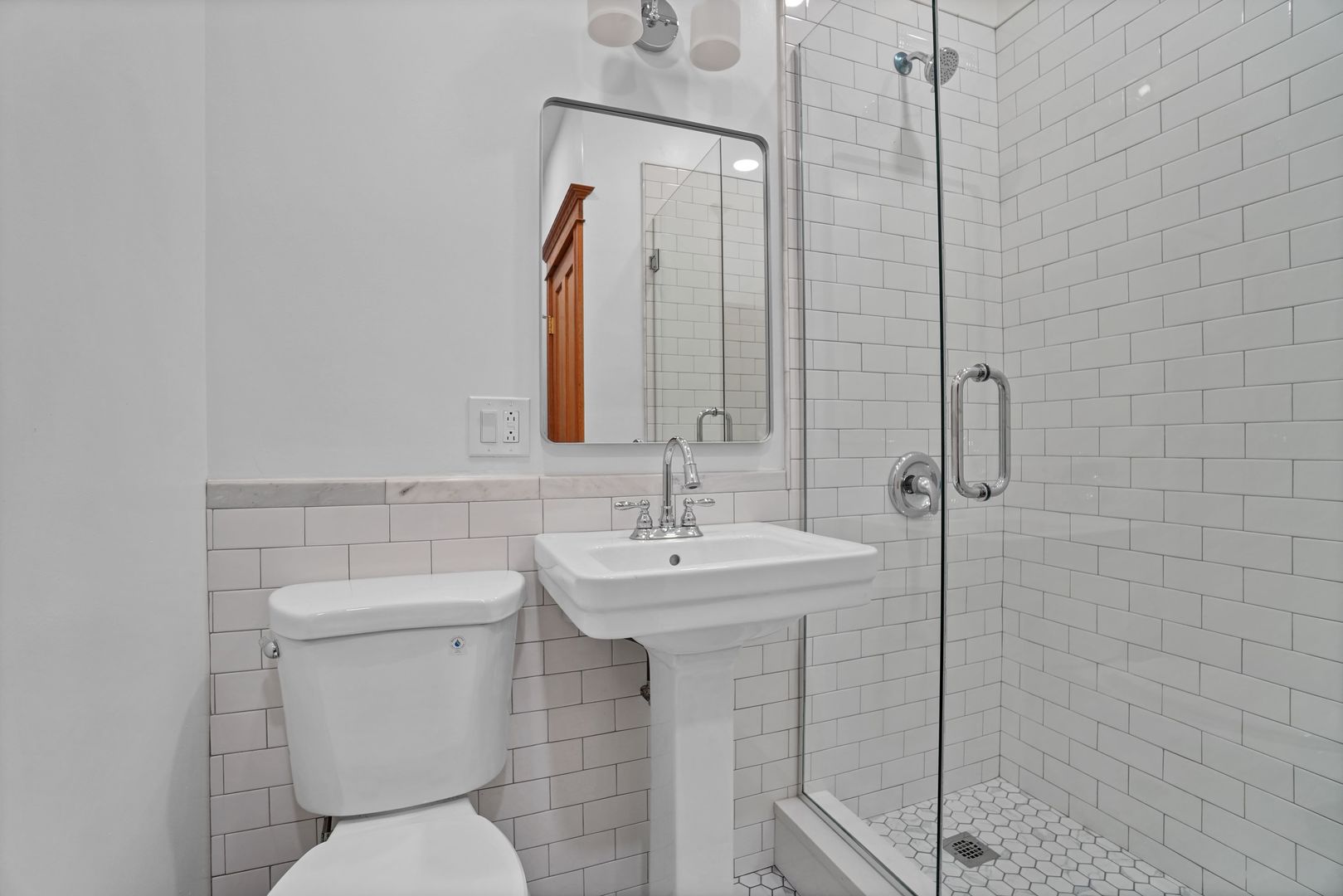 849 West Grace Street, Unit 2 Chicago, IL 60613 - Photo 17 of 19 a bathroom with a toilet sink and mirror