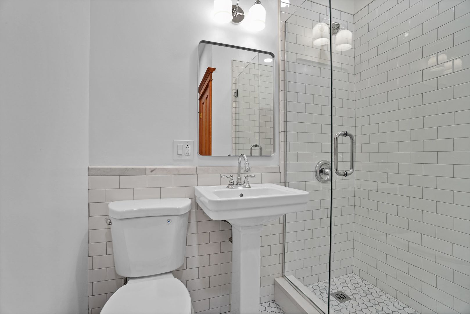 849 West Grace Street, Unit 2 Chicago, IL 60613 - Photo 19 of 19 a bathroom with a toilet sink and mirror