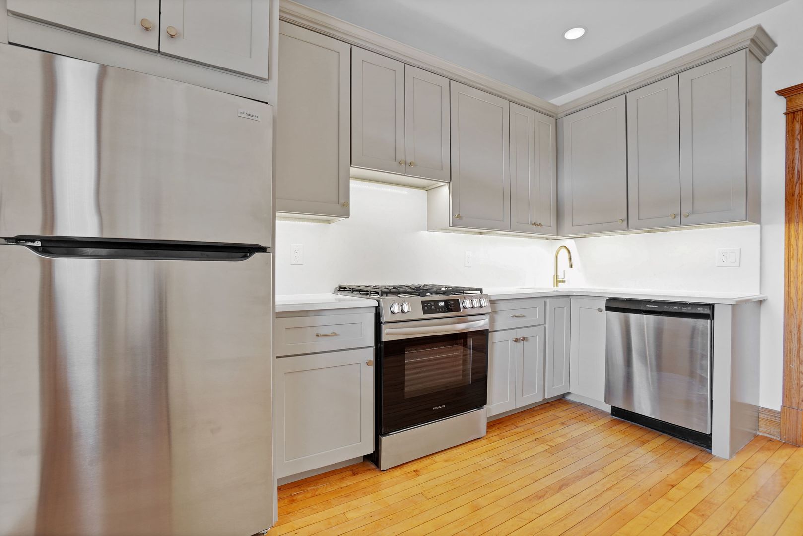 849 West Grace Street, Unit 2 Chicago, IL 60613 - Photo 5 of 19 a kitchen with stainless steel appliances white cabinets and a refrigerator