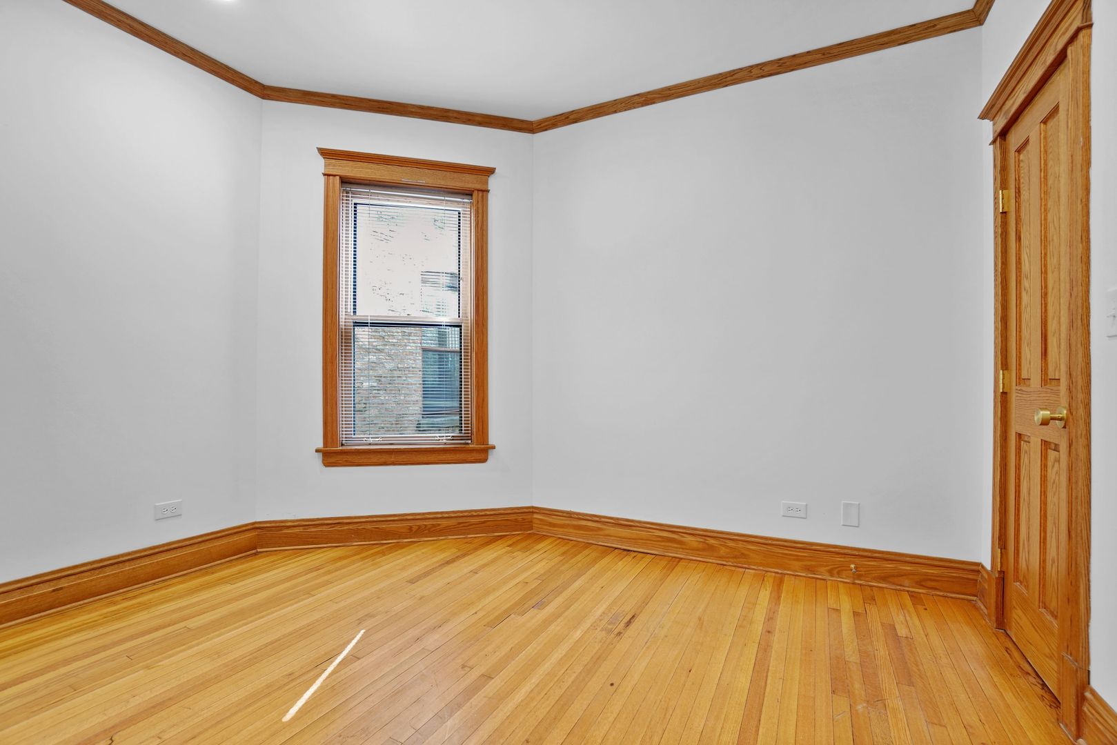 849 West Grace Street, Unit 2 Chicago, IL 60613 - Photo 7 of 19 a view of an empty room with wooden floor and a window