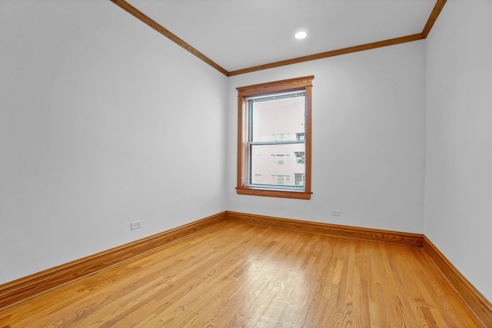 849 West Grace Street, Unit 2 Chicago, IL 60613 - Photo 9 of 19 an empty room with wooden floor and windows