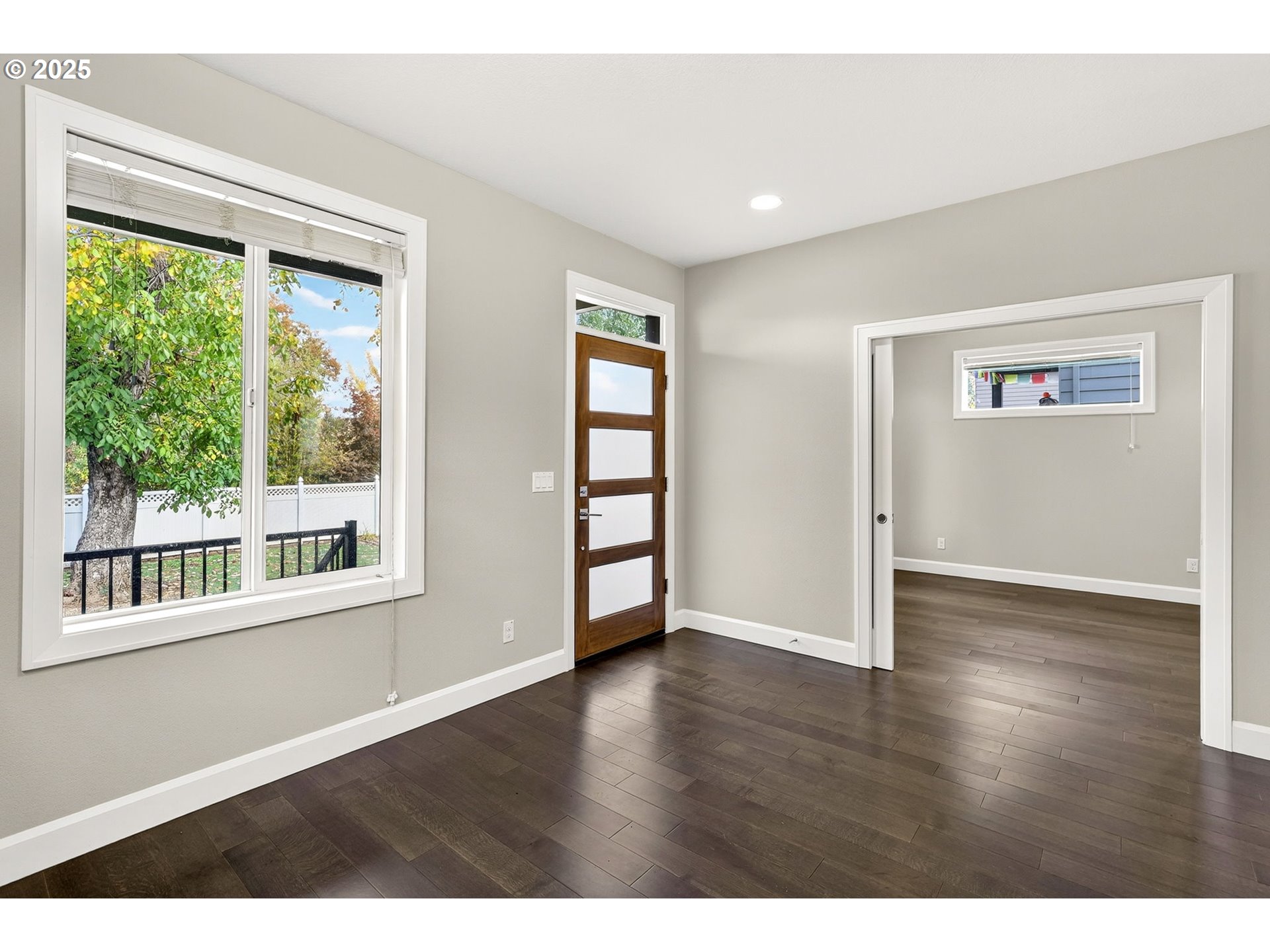 7830 Southeast Boise Court Portland, OR 97206 - Photo 11 of 48 a view of an empty room with wooden floor and a window