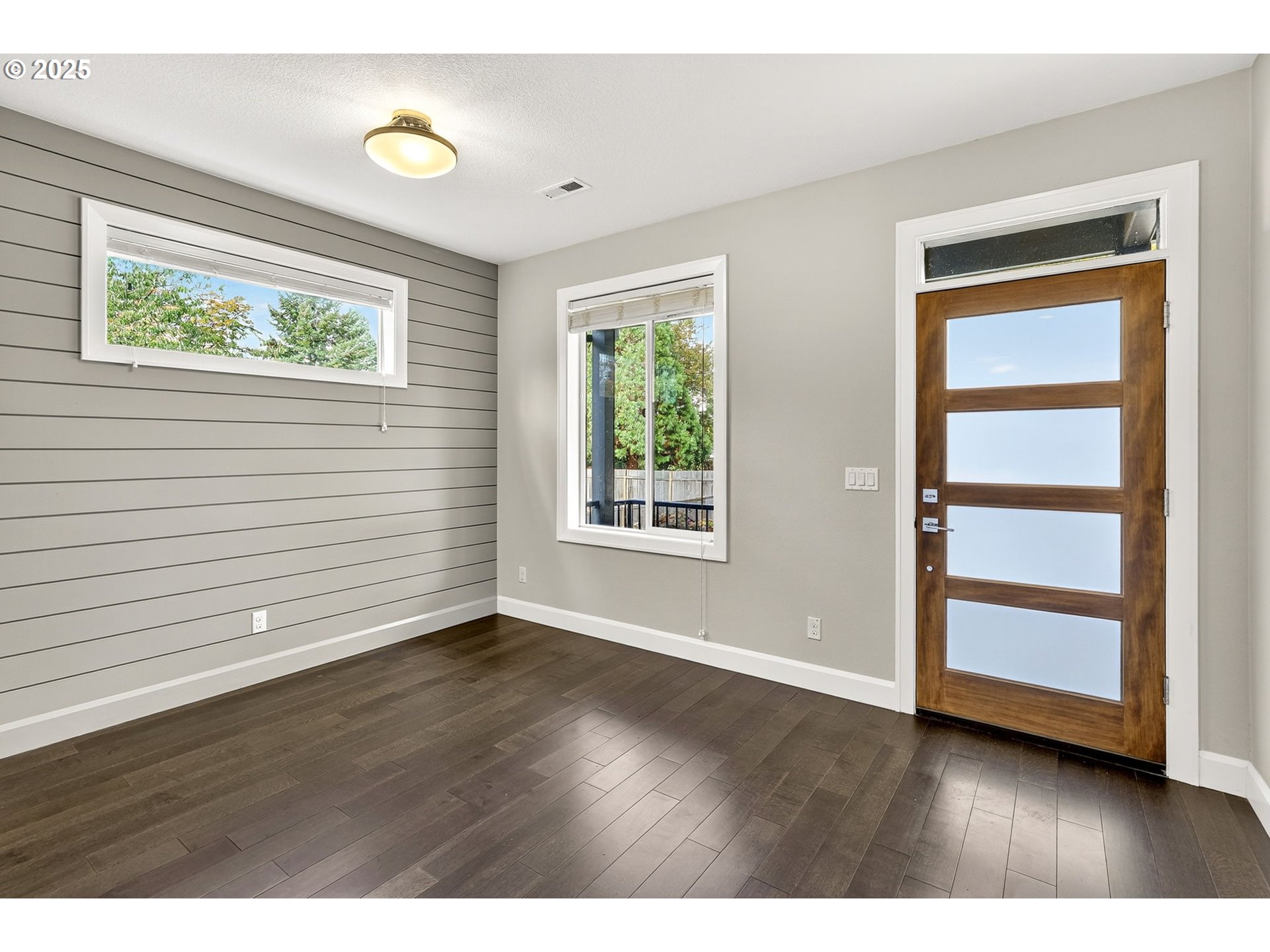 7830 Southeast Boise Court Portland, OR 97206 - Photo 13 of 48 a view of an empty room with a window and wooden floor