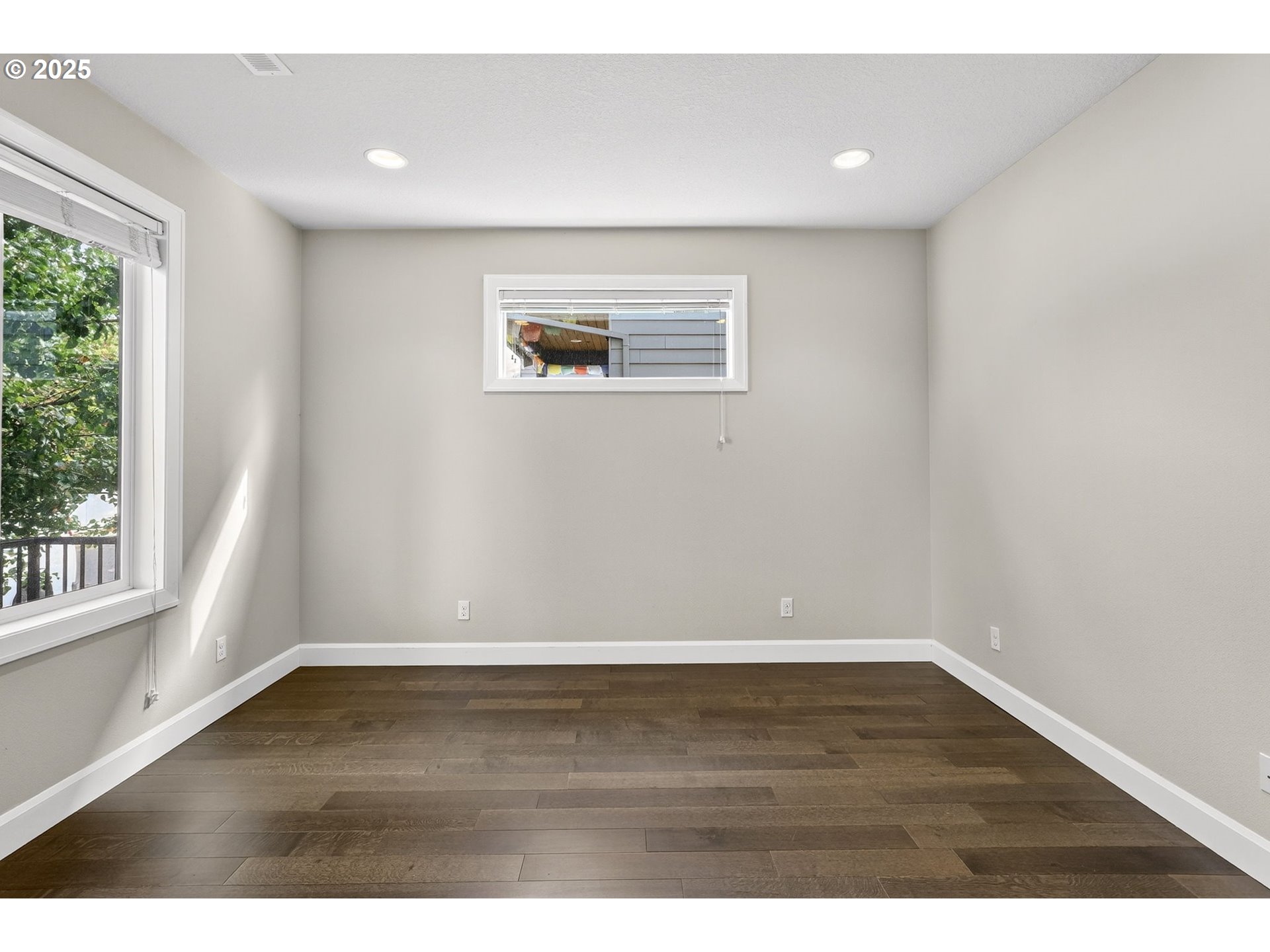 7830 Southeast Boise Court Portland, OR 97206 - Photo 14 of 48 an empty room with wooden floor and windows
