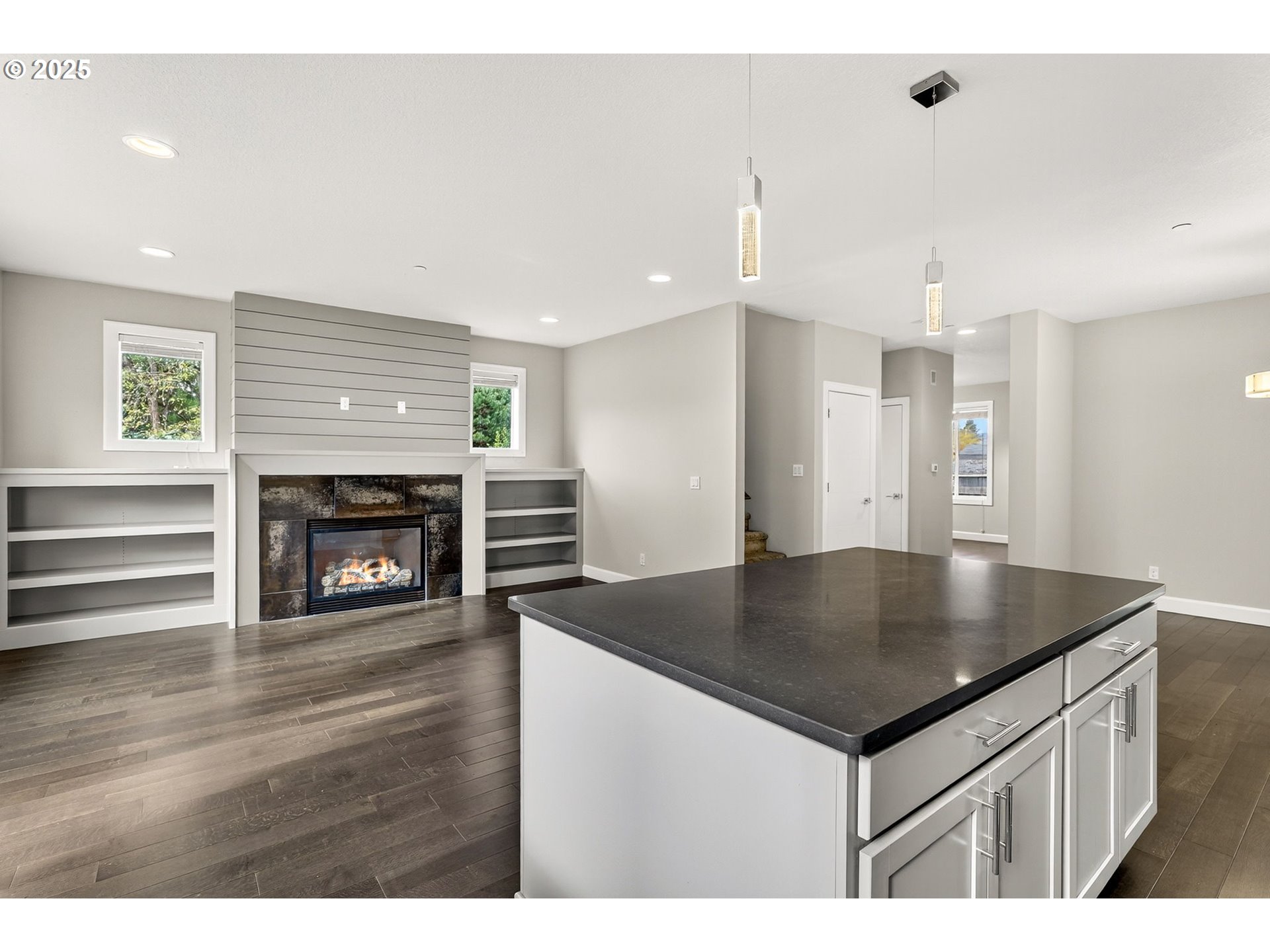 7830 Southeast Boise Court Portland, OR 97206 - Photo 21 of 48 a kitchen with stainless steel appliances granite countertop a sink dishwasher and a fireplace with wooden floor