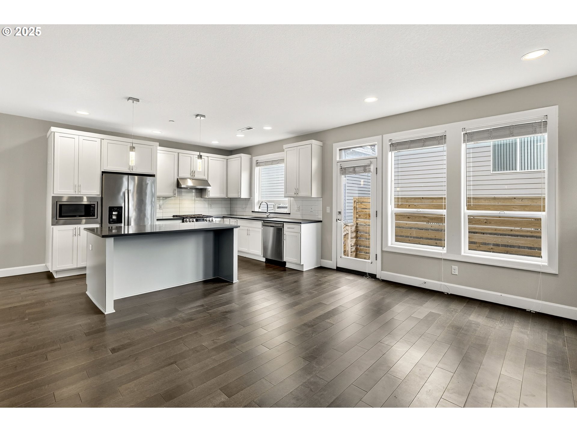 7830 Southeast Boise Court Portland, OR 97206 - Photo 24 of 48 a kitchen with stainless steel appliances granite countertop a stove top oven a sink and a refrigerator