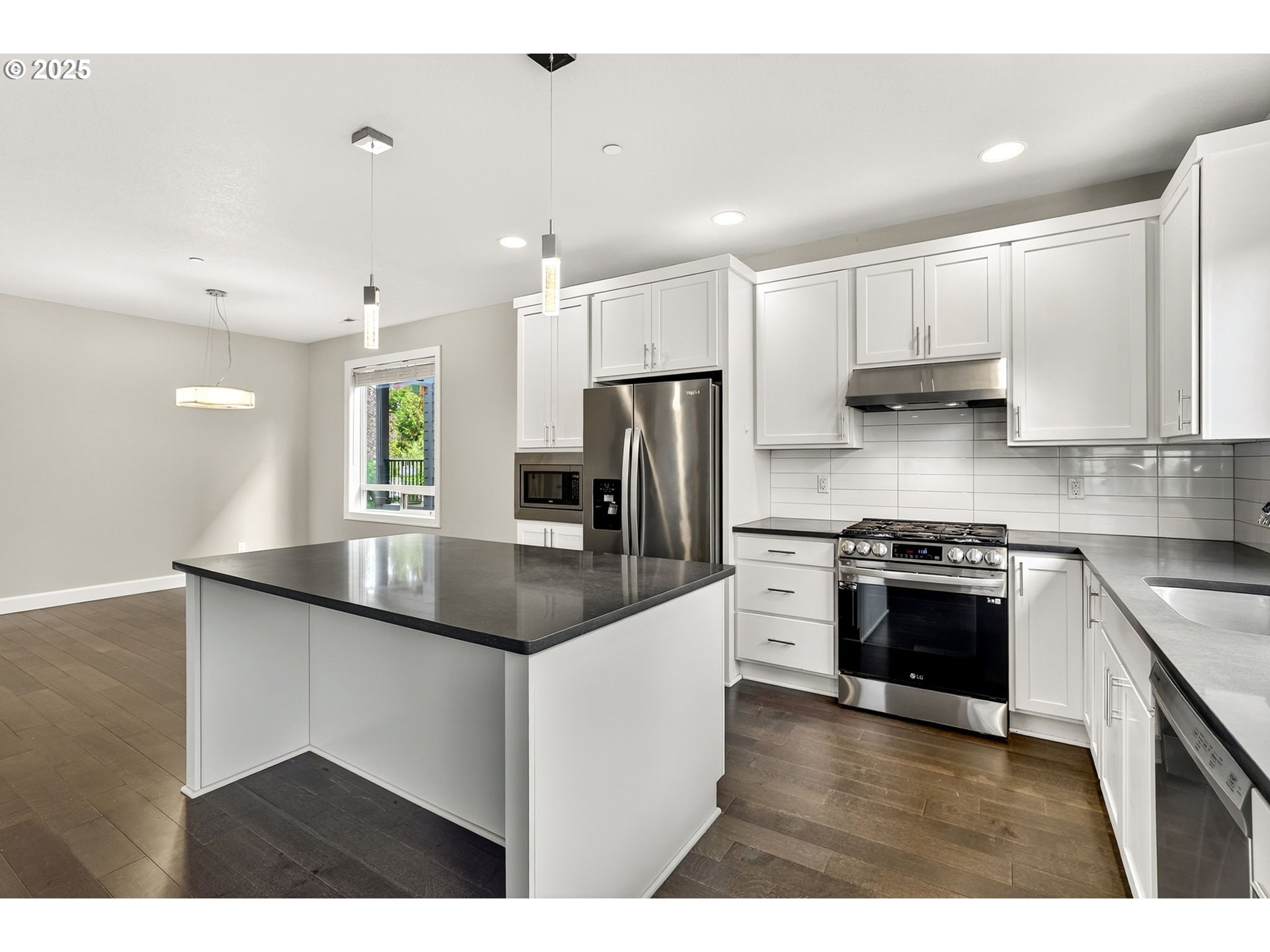 7830 Southeast Boise Court Portland, OR 97206 - Photo 26 of 48 a kitchen with stainless steel appliances granite countertop a sink a stove a refrigerator a center island and a cabinets