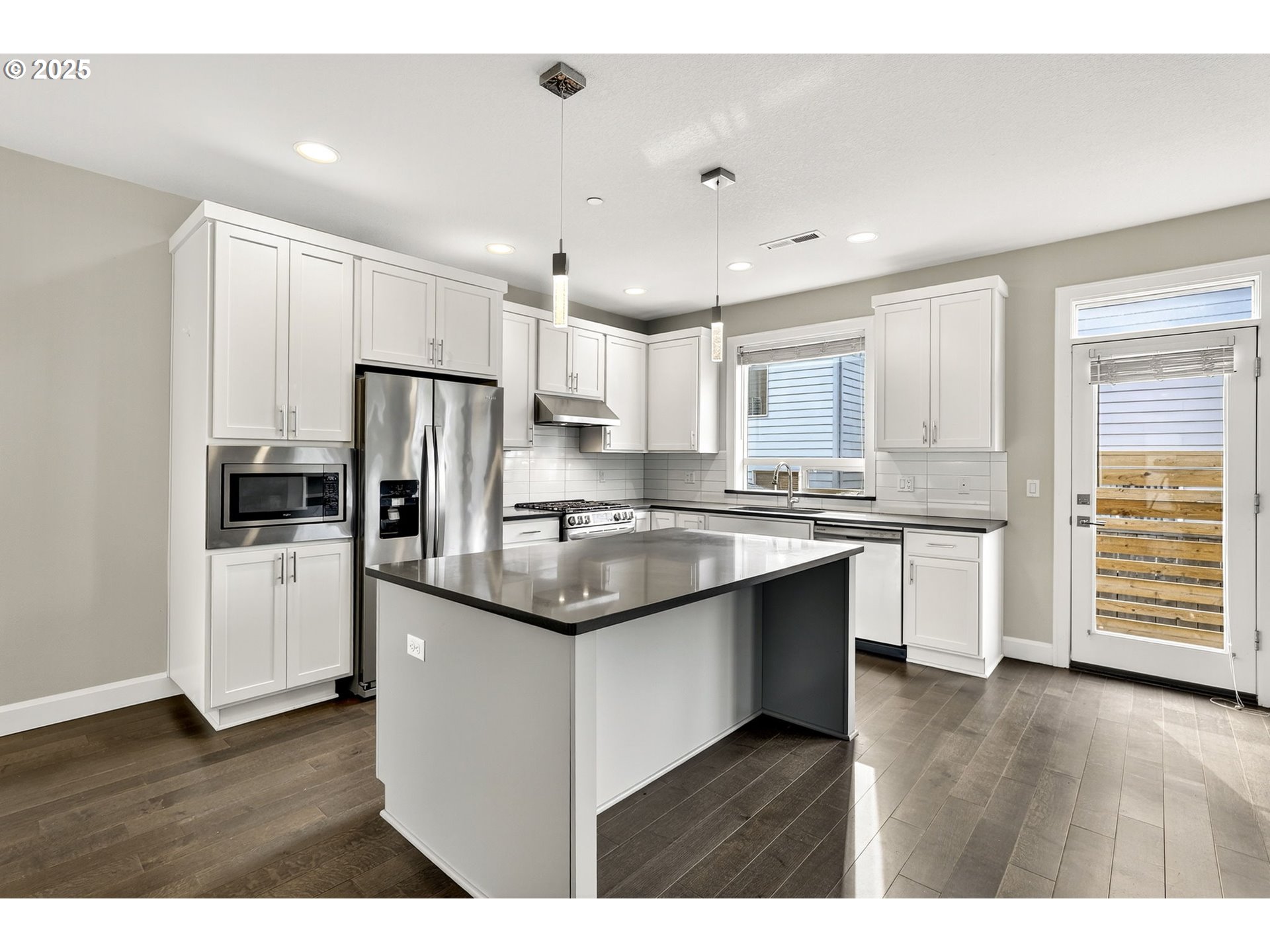 7830 Southeast Boise Court Portland, OR 97206 - Photo 28 of 48 a kitchen with stainless steel appliances granite countertop a refrigerator and a stove top oven