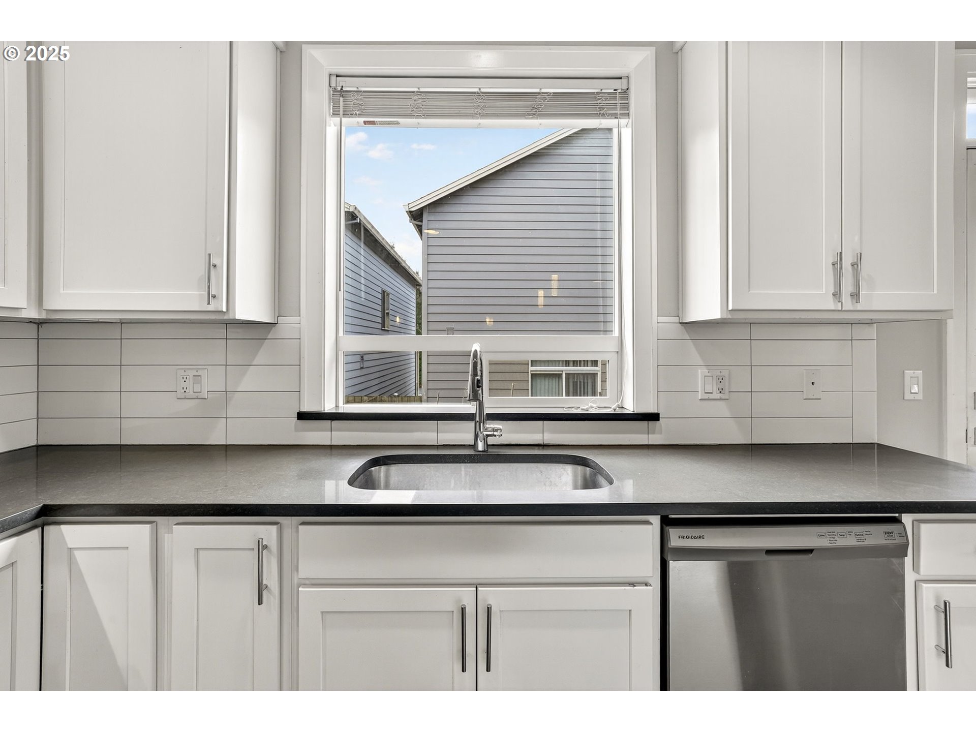 7830 Southeast Boise Court Portland, OR 97206 - Photo 29 of 48 a kitchen with stainless steel appliances granite countertop a sink and a white cabinets