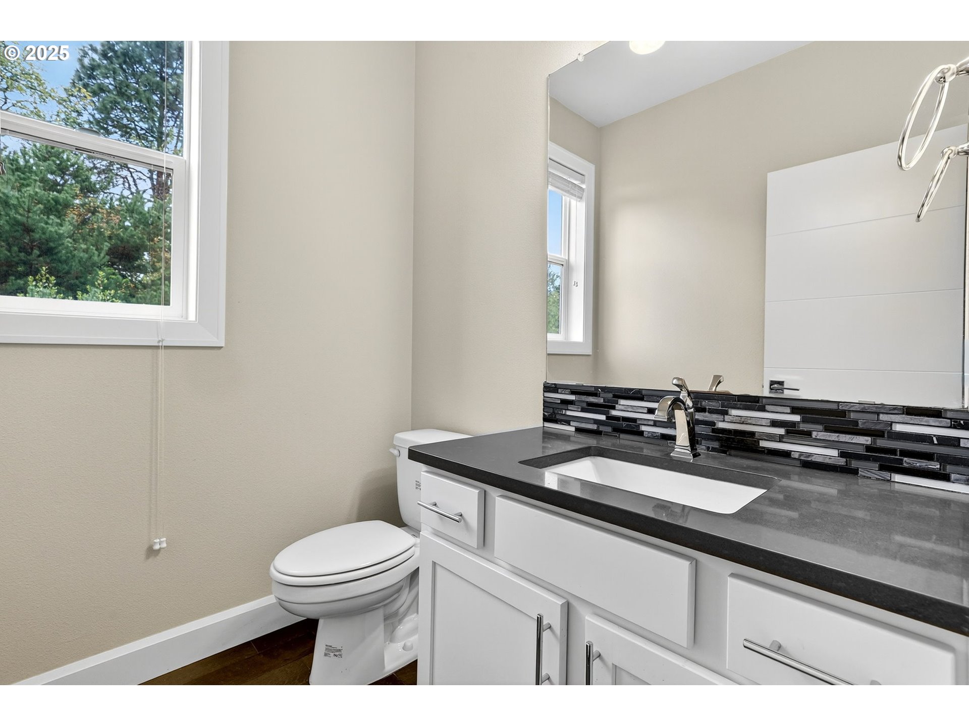 7830 Southeast Boise Court Portland, OR 97206 - Photo 31 of 48 a bathroom with a granite countertop toilet a sink and a mirror