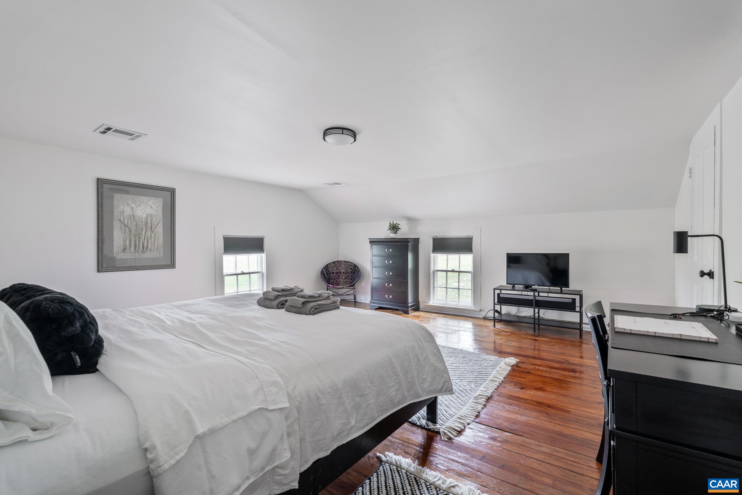 1859 Rivanna Farm Charlottesville, VA 22911 - Photo 37 of 45 a bedroom with a bed and wooden floor