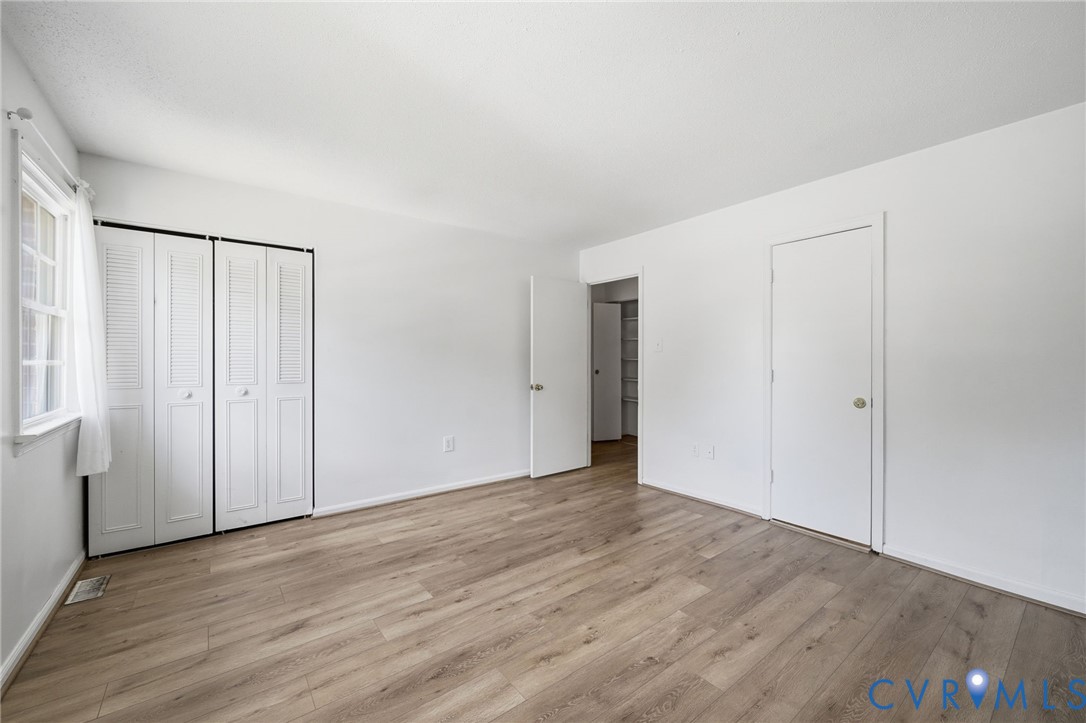 1501 Ivymount Road Richmond, VA 23225 - Photo 10 of 31 Light wood-finish flooring, white walls, and a win
