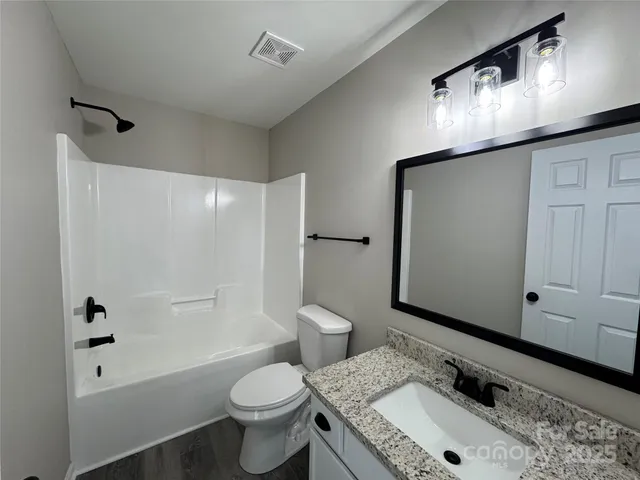 a bathroom with a sink toilet tub and shower
