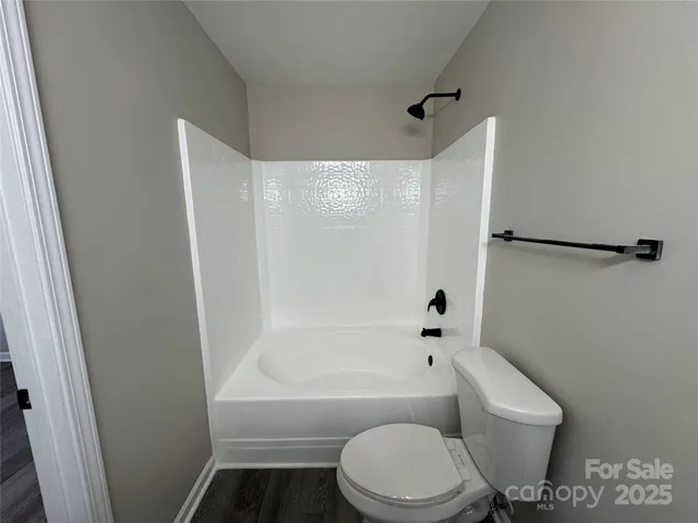 a bathroom with a toilet and a bathtub