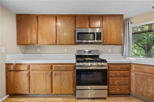 a kitchen with granite countertop a stove and a sink