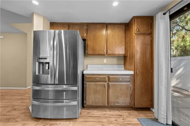 a kitchen with stainless steel appliances granite countertop a refrigerator and a sink