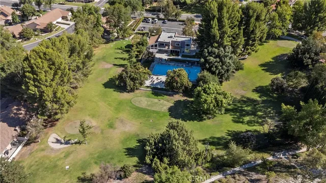 an aerial view of residential houses with outdoor space and parking